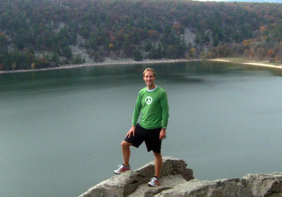 Francis Eanes standing on a rock overlooking a lake