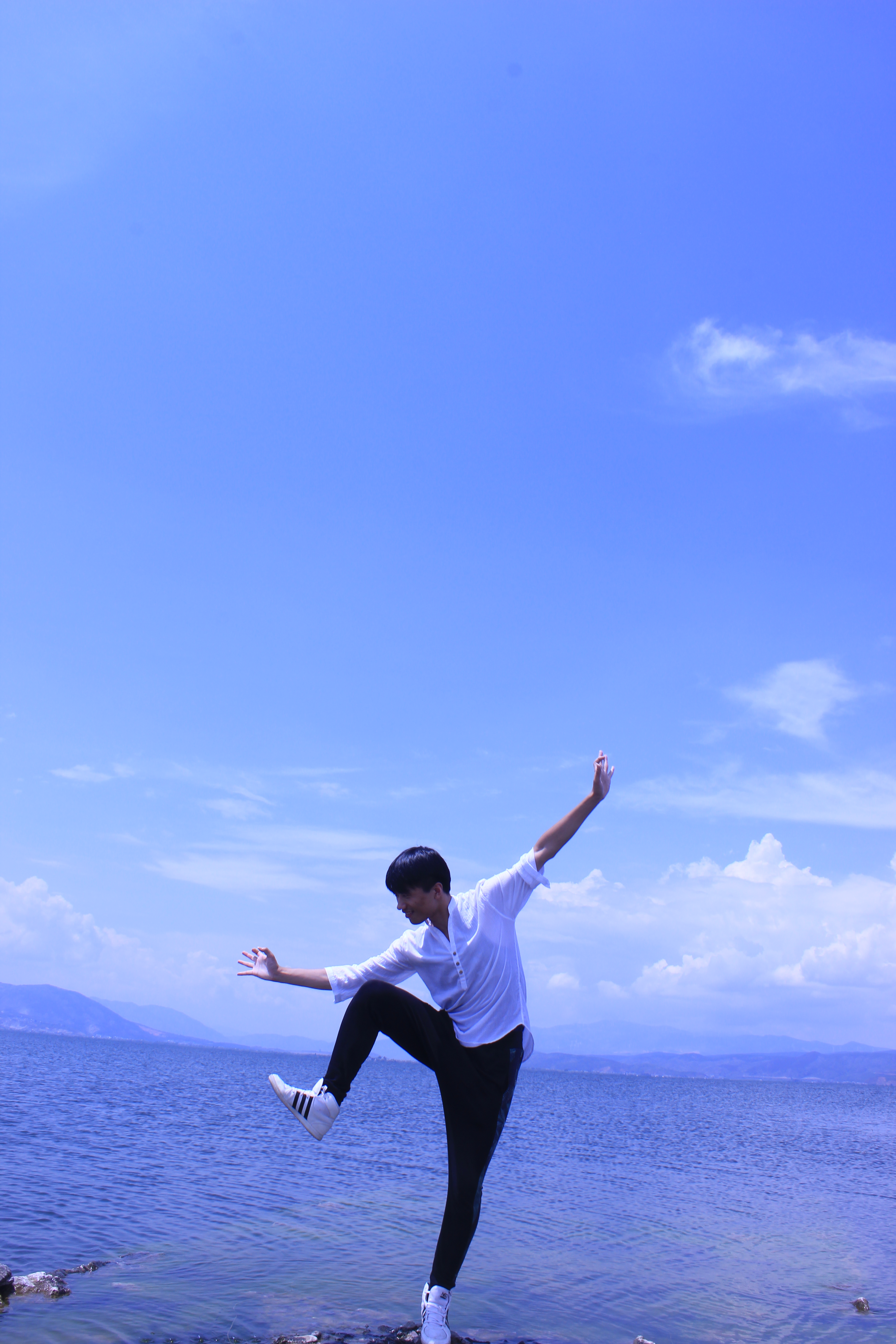 Sulong in dance pose at Erhai Sea in Yunnan